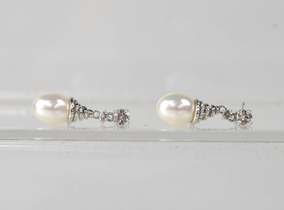 Lot 1184 - A pair of white metal and pearl drop earrings,...