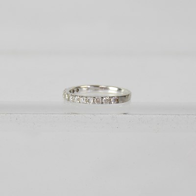 Lot 935 - A 9ct white gold and diamond set half eternity...