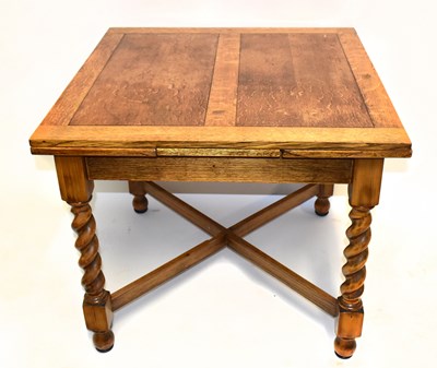 Lot 1491 - A 1930s oak draw-leaf table, with twist legs,...