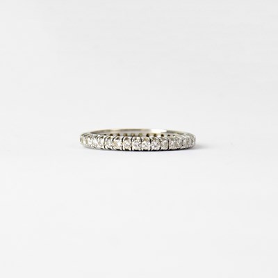 Lot 989 - A white metal and diamond full eternity ring,...