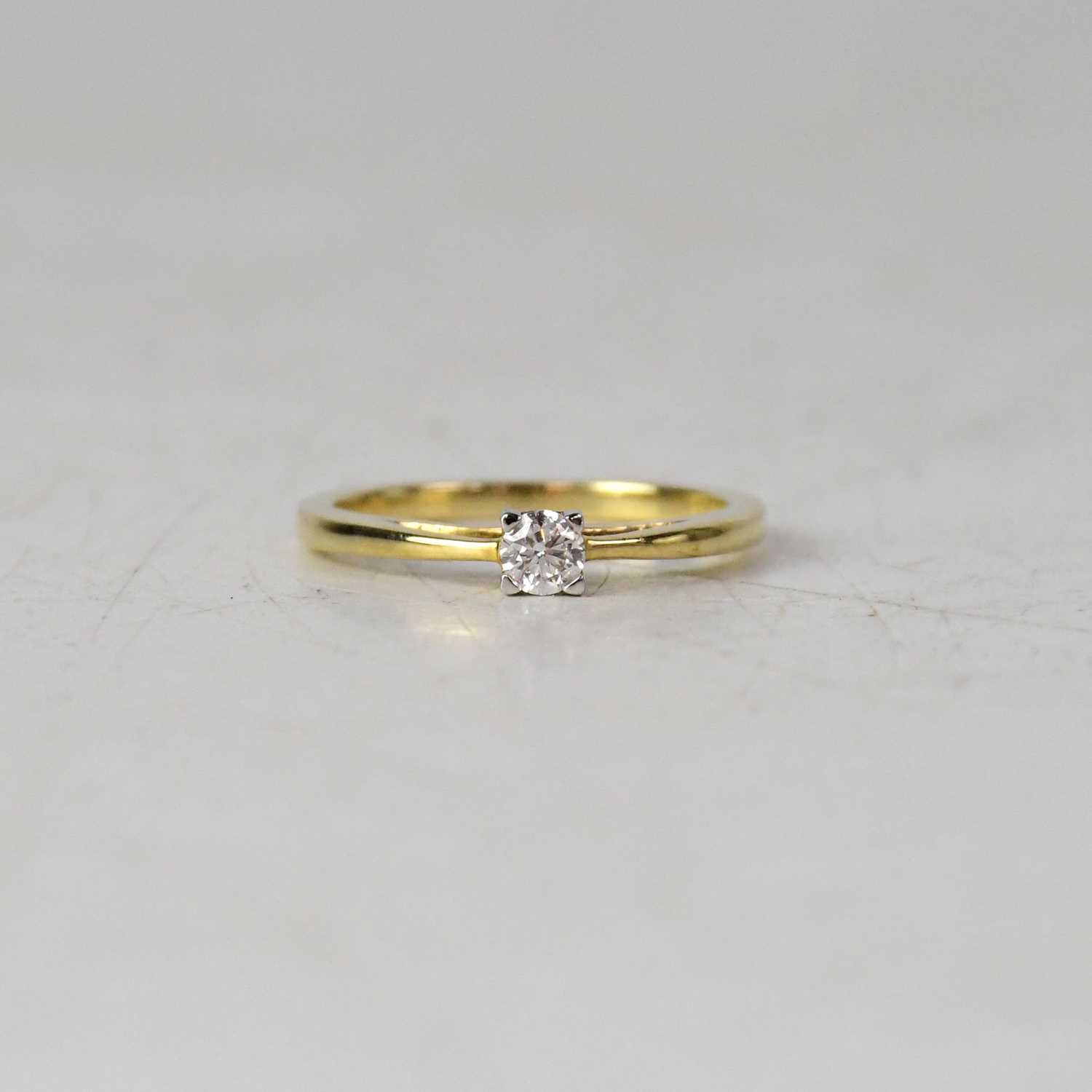 Lot 936 - A 9ct yellow gold diamond solitaire ring, the...