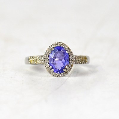 Lot 1205 - A platinum tanzanite and diamond oval halo...