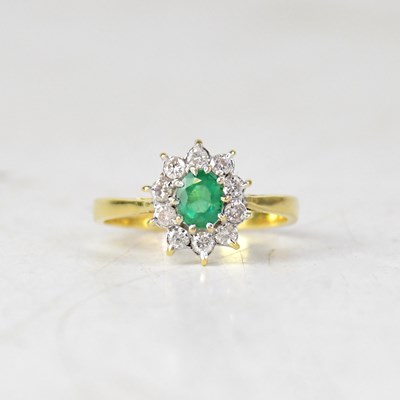 Lot 919 - An 18ct yellow gold emerald and diamond...