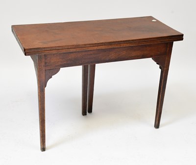 Lot 45 - A mahogany fold-over gateleg tea table raised...