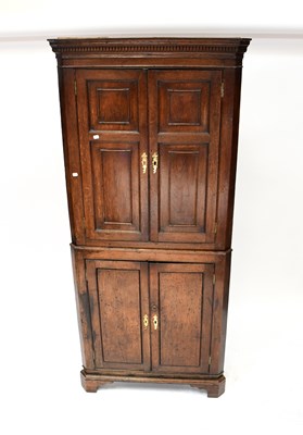 Lot 29 - A late George III oak freestanding corner...