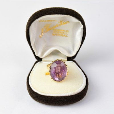 Lot 937 - A 9ct yellow gold dress ring set with an oval...