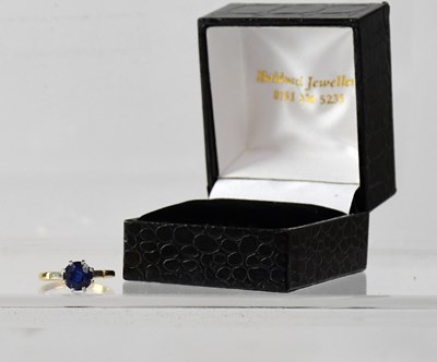 Lot 1002 - A 9ct yellow gold dress ring set with dark...