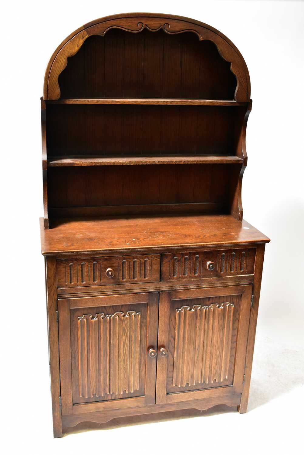 Lot 27 A reproduction oak dresser with domed rack,