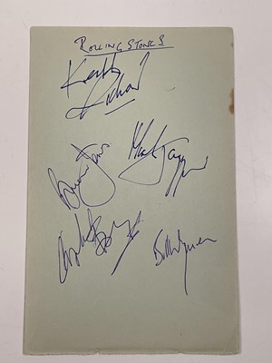 Lot 2056 - THE ROLLING STONES; a page from an autograph...