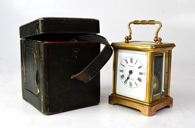 Lot 109 - A c.1900 leather cased brass carriage clock,...