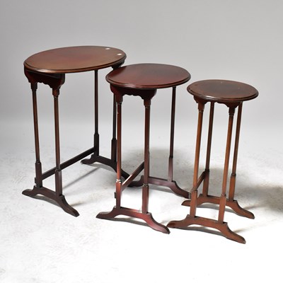 Lot 49 - A nest of three oval mahogany side tables, to...