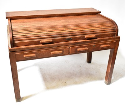 Lot 36 - A c.1930s oak office desk with tambour...