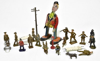 Lot 2263 - A Japanese clockwork tinplate figure of a...