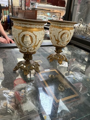Lot 238 - A pair of gilded vases with applied winged...