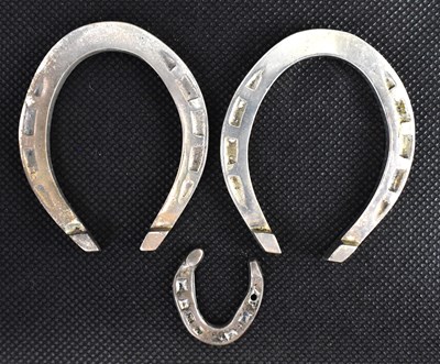 Lot 735 - Three hallmarked silver lucky horseshoes, two...