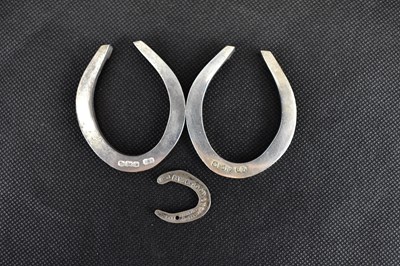 Lot 735 - Three hallmarked silver lucky horseshoes, two...