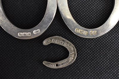 Lot 735 - Three hallmarked silver lucky horseshoes, two...