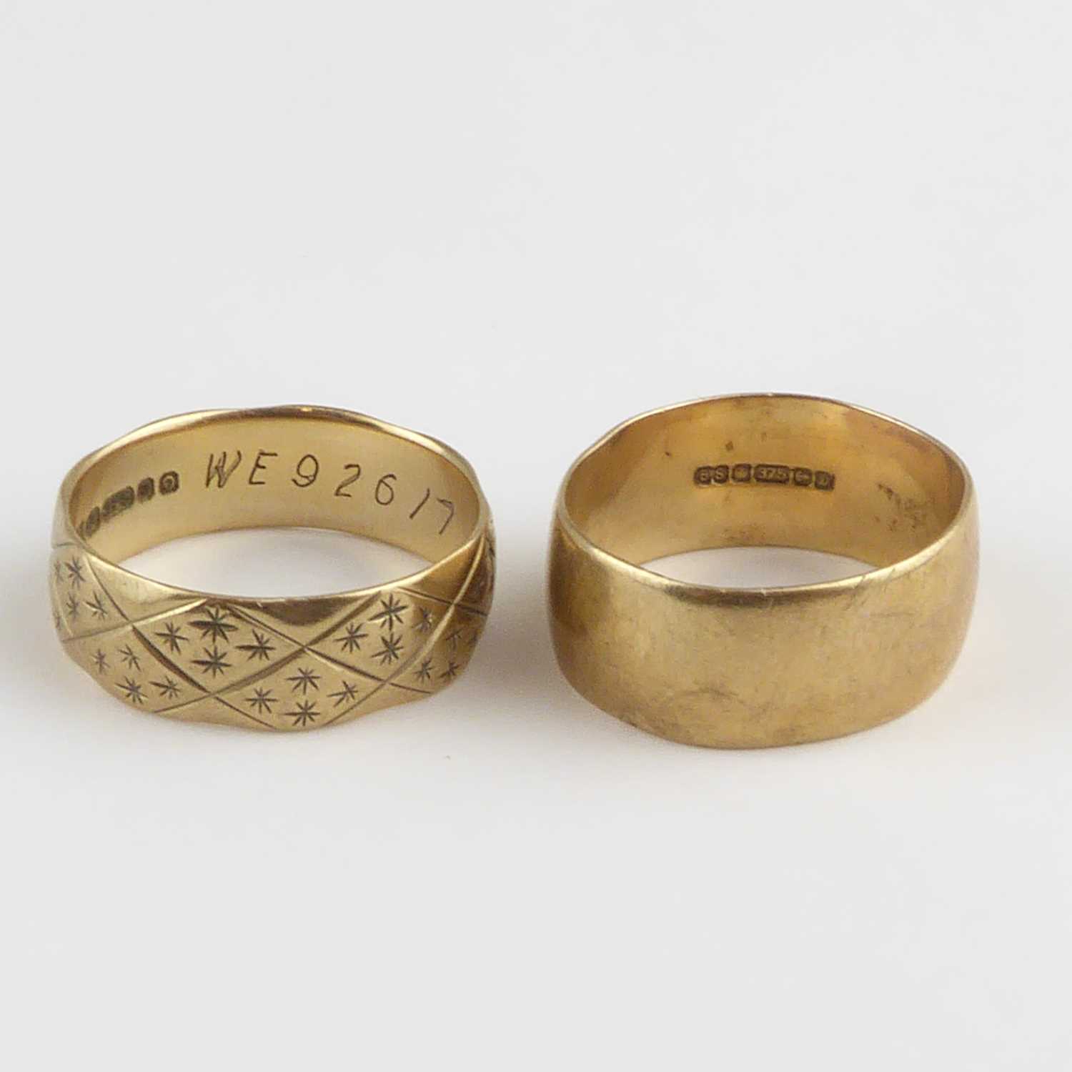 Lot 907 - Two 9ct gold wedding bands, one with textured...