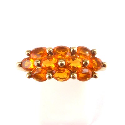 Lot 988 - A 9ct gold cluster ring set with orange...