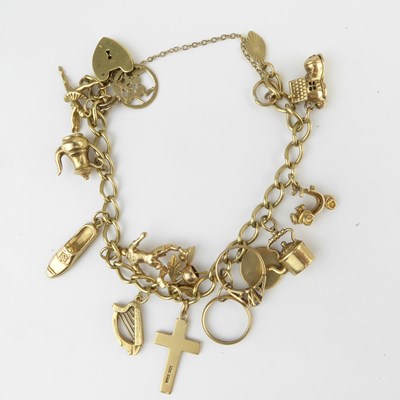 Lot 1048 - A 9ct gold charm bracelet with 9ct gold...