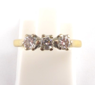 Lot 942 - An 18ct gold three-stone diamond ring, the...
