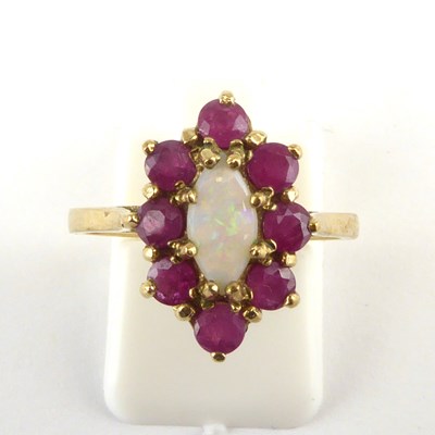 Lot 961 - A 9ct gold opal and ruby cluster ring, the...