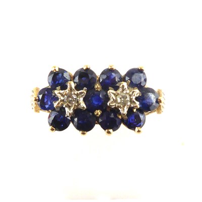 Lot 989 - A 9ct gold diamond and sapphire ring, the two...