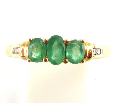 Lot 997 - A 9ct gold three-stone dress ring, with three...