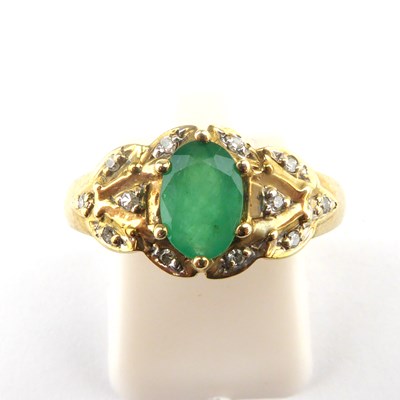 Lot 886 - A 9ct gold emerald and diamond ring, the oval...