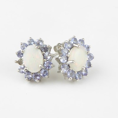Lot 1182 - A pair of 9ct white gold opal cluster earrings,...