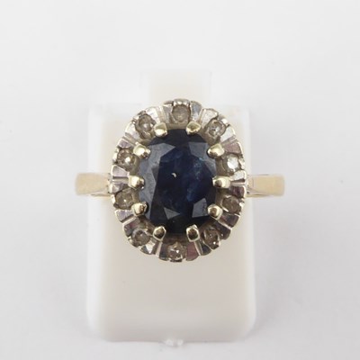 Lot 927 - A 9ct gold diamond and sapphire ring, the claw...