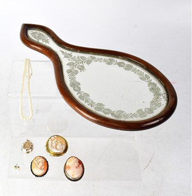 Lot 1230 - A shell cameo brooch carved with a couple in a...