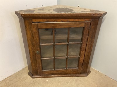 Lot 658 - An oak glazed flat fronted hanging corner...