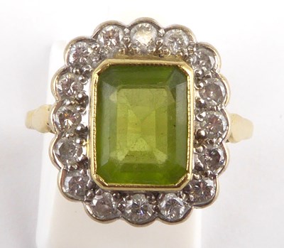 Lot 852 - An 18ct gold peridot and diamond set cluster...