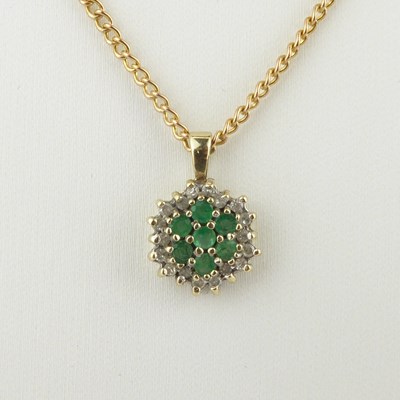 Lot 1114 - A 9ct gold green and white gem set cluster...