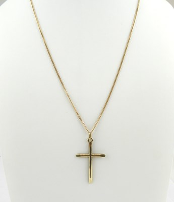 Lot 1102 - A 9ct gold cross, length 3.3cm, on a 9ct gold...