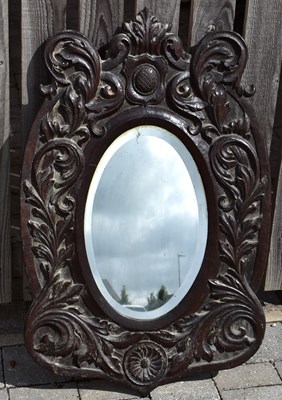 Lot 77 - A wall-mounted oval bevel edged mirror, 44 x...