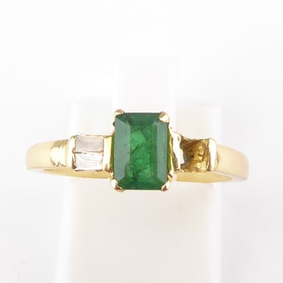 Lot 973 - A gold diamond and emerald ring, the emerald...