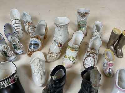Lot 188 - A collection of ornamental ceramic shoes, many...