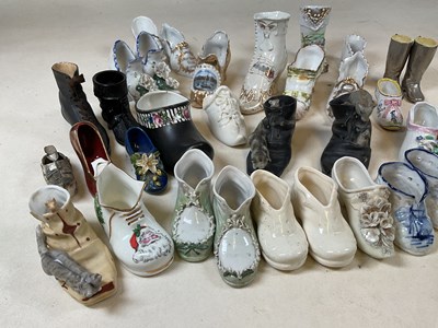 Lot 188 - A collection of ornamental ceramic shoes, many...