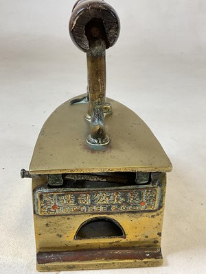 Lot 155 - LEONG BEE & CO; a brass flat iron with turned...