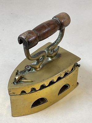 Lot 155 - LEONG BEE & CO; a brass flat iron with turned...
