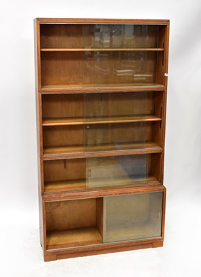 Lot 25 - MINTY; a four-tier oak bookcase with glazed...