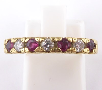 Lot 893 - An 18ct gold ruby and diamond half eternity...