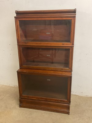 Lot 525 - GLOBE WERNICKE; a three tiered stacking...