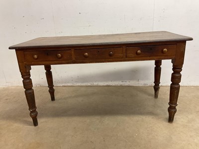 Lot 562 - A pine table with three drawers, height 74cm,...
