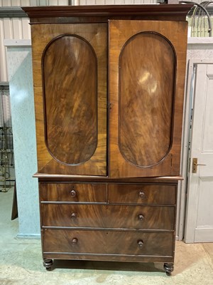 Lot 570 - A 19th century mahogany linen press with two...