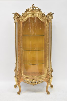 Lot 63 - SILIK; a Rococo-style gilt bow-fronted display...