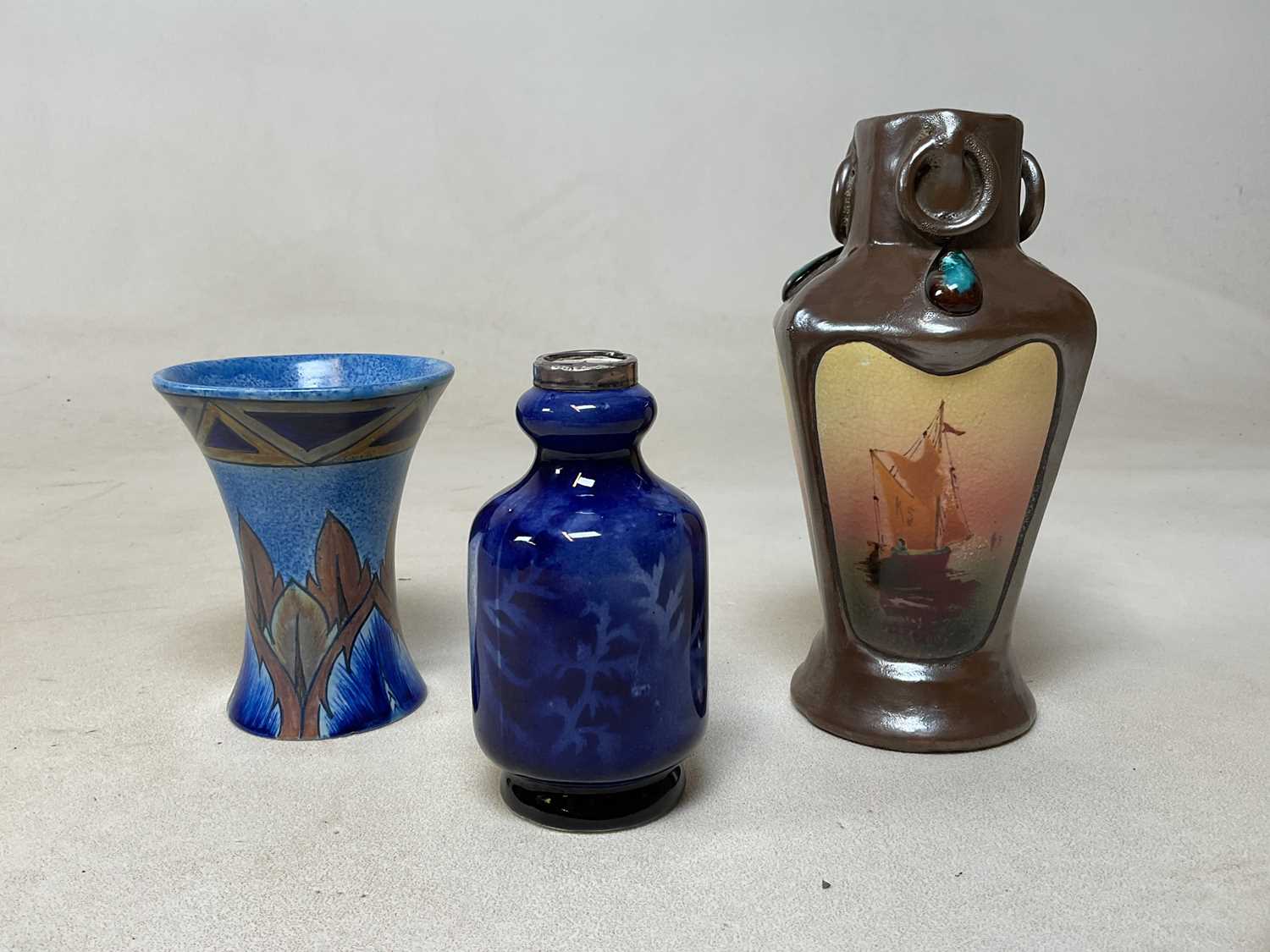 Lot 179 - Three early 20th century British pottery vases,...