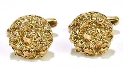 Lot 682 - A pair of yellow metal cufflinks with textured...